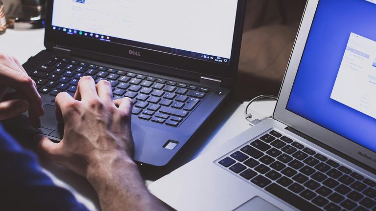 A student on a laptop with a fully managed LMS